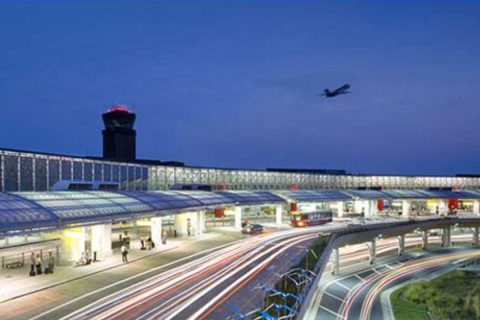 International Airport terminal at dusk with light trails